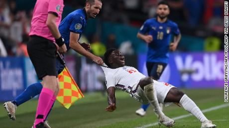 Giorgio Chiellini drags Bukayo Saka after being turned by the England forward.