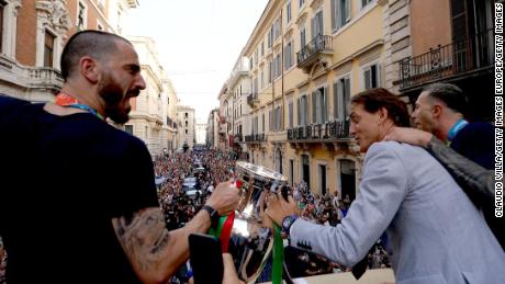 Leonardo Bonucci and Roberto Mancini celebrate during national team&#39;s open-top bus parade in Rome.