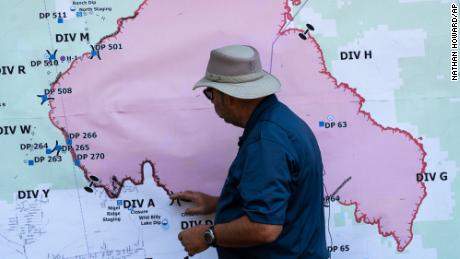 Operations Section Chief Bert Thayer examines a map of the Bootleg Fire on Tuesday in Chiloquin, Oregon. 