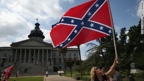 Barbie Byrd, of Columbia, South Carolina joins a group of demonstrators on the grounds of the South Carolina State House calling for the Confederate flag to remain on the State House grounds. 