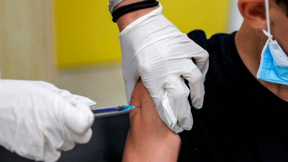 A boy receives a dose of the Pfizer/BioNTech Covid-19 vaccine at the Clalit Healthcare Services in the Israeli city of Holon near Tel Aviv on June 21, 2021, as Israel begins coronavirus vaccination campaign for 12 to 15-year-olds. - Israel is now urging more 12- to 15-year-olds to be vaccinated, citing new outbreaks attributed to the more infectious Delta variant. (Photo by JACK GUEZ / AFP) (Photo by JACK GUEZ/AFP via Getty Images)