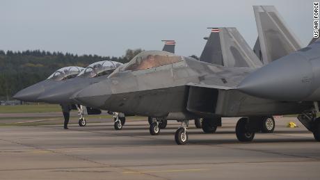 A US Air Force F-22 Raptor lines up next to three F-15E Strike Eagles at Royal Air Force Lakenheath, England, in 2017. 