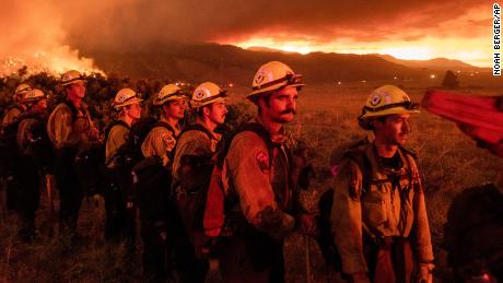 Firefighters from Cal Fire&#39;s Placerville station monitor the Sugar Fire, part of the Beckwourth Complex Fire, in Doyle, California, on Friday, July 9.