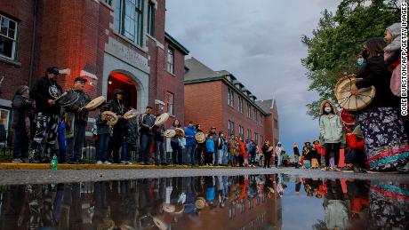 Drummers line the front of the former Kamloops Indian Residential School to welcome a group of runners from the Syilx Okanagan Nation on June 5, 2021.