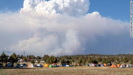 A cloud caused by the Bootleg Fire drifts into the air north of the Bootleg Fire forward operating base in Bly, Oregon, on July 15, 2021.