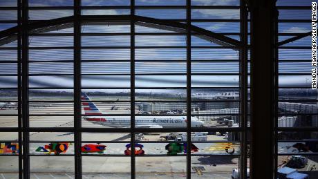 An American Airlines plane is seen from a terminal of Reagan National Airport in Arlington, Virginia on March 17, 2020.