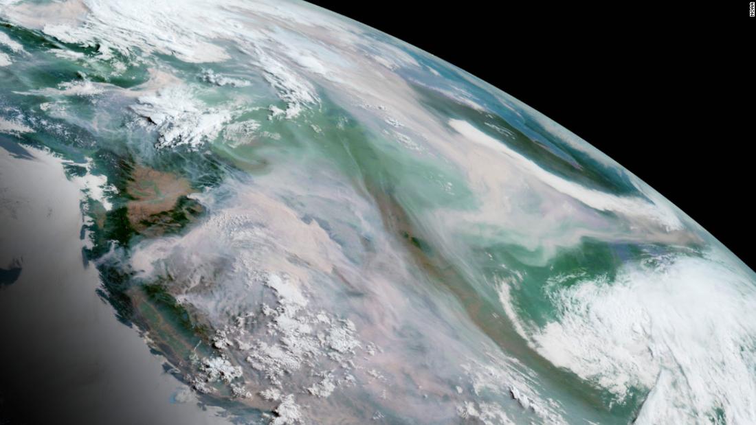 In this GeoColor image from July 12, smoke from numerous wildfires could be seen as gray-brown, in stark contrast to the white cloud cover over other parts of the continent.