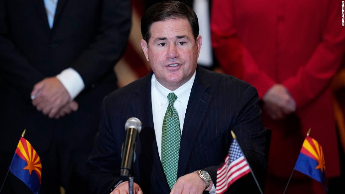 Arizona governor says schools can't force unvaccinated students to quarantine if they're exposed to Covid-19