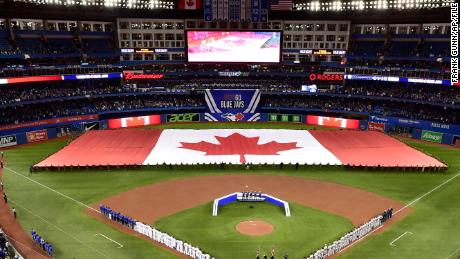 Members of the Toronto Blue Jays and the Detroit Tigers lineup before an opening day baseball game at Rogers Centre in Toronto in this Thursday, March 28, 2019, file photo.