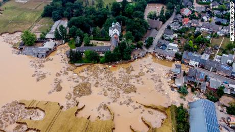 A damaged castle, left, is seen in Erftstadt-Blessem, Germany on Saturday July 17, 2021. 