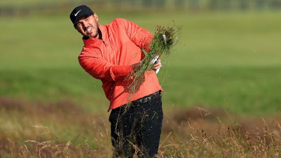 Koepka plays his second shot on the 1st hole.