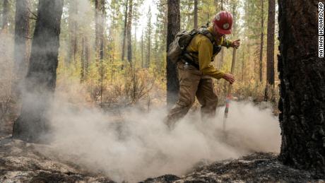 Firefighter Garrett Suza, with the Chiloquin Forest Service, mops up a hot spot on the northeast side of the Bootleg Fire, Wednesday, July 14, 2021, near Sprague River, Oregon. 