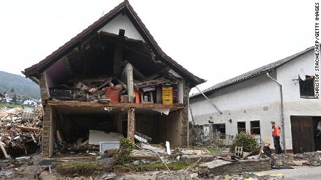  A man stands in front of a destroyed house after floods caused major damage in Schuld near Bad Neuenahr-Ahrweiler, western Germany, on July 17, 2021.