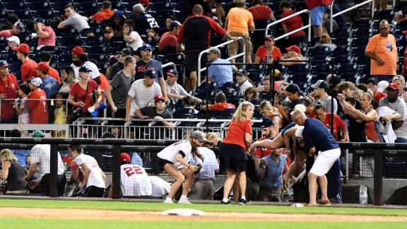 Fans run for cover after what was believed to be shots were heard during a baseball game between the San Diego Padres and the Washington Nationals at Nationals Park on July 17, 2021 in Washington, DC. 