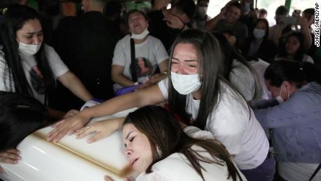 Relatives of Leidy Vanessa Luna Villalba mourn over her coffin during a wake at her home in Eugenio Garay, Paraguay, Tuesday, July 13, 2021. 