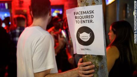 Face mask plates are displayed outside the Trunks bar in West Hollywood, California, early at midnight on Sunday morning.  Warnings are required by the province indoors that protected people be protected again. 