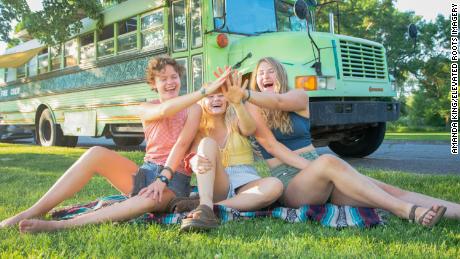 From left to right, Bekah King, Morgan Tabor, and Abi Roberts in front of the BAM bus.