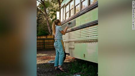 Abi Roberts painting the bus before the trip.