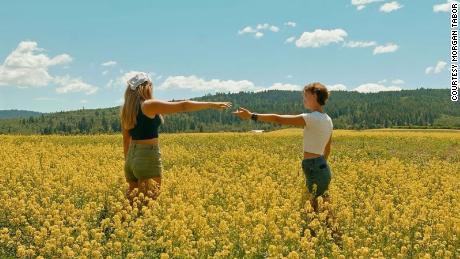 Abi Roberts, left, and Bekah King, right, at a field they stopped at during their road trip.