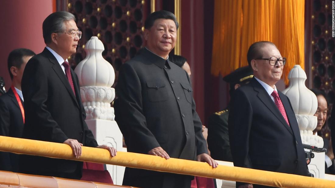 Chinese President Xi Jinping, center, attends a military parade with former presidents Hu Jintao, left, and Jiang Zemin in Tiananmen Square in Beijing on October 1, 2019.