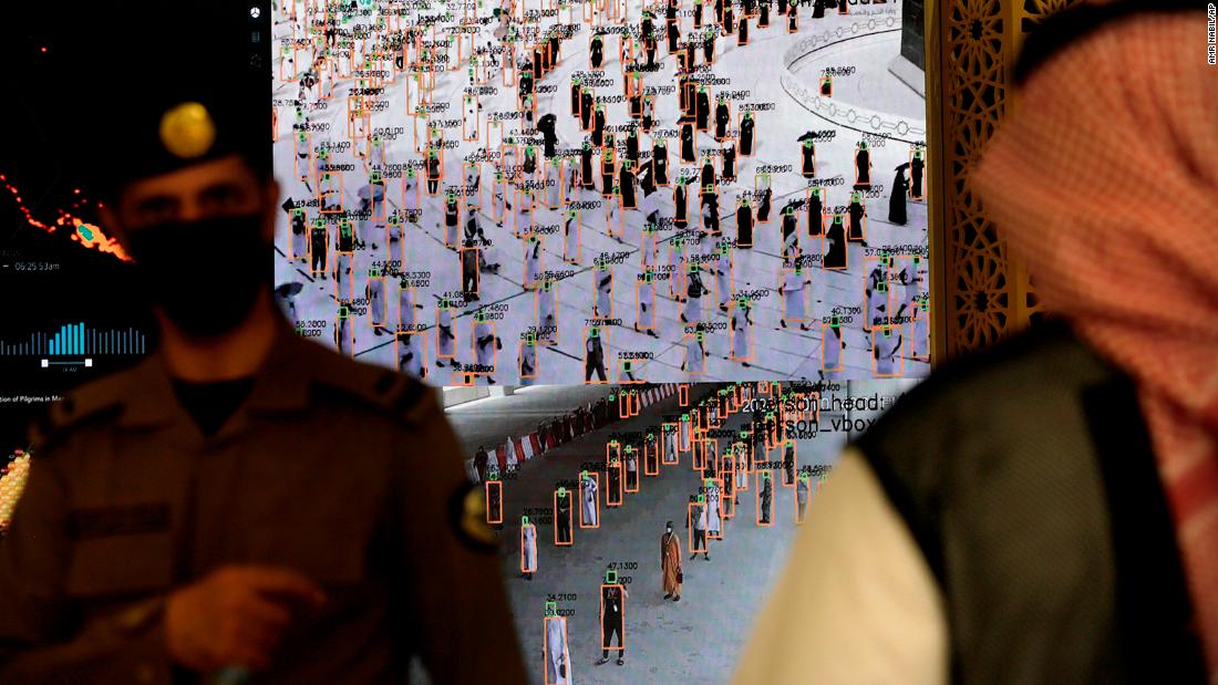 Security personnel use smart screens to watch pilgrims at a reception center in Mecca on July 12.