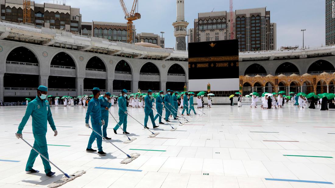 Workers at the Grand Mosque disinfect the grounds around the Kaaba on Saturday.