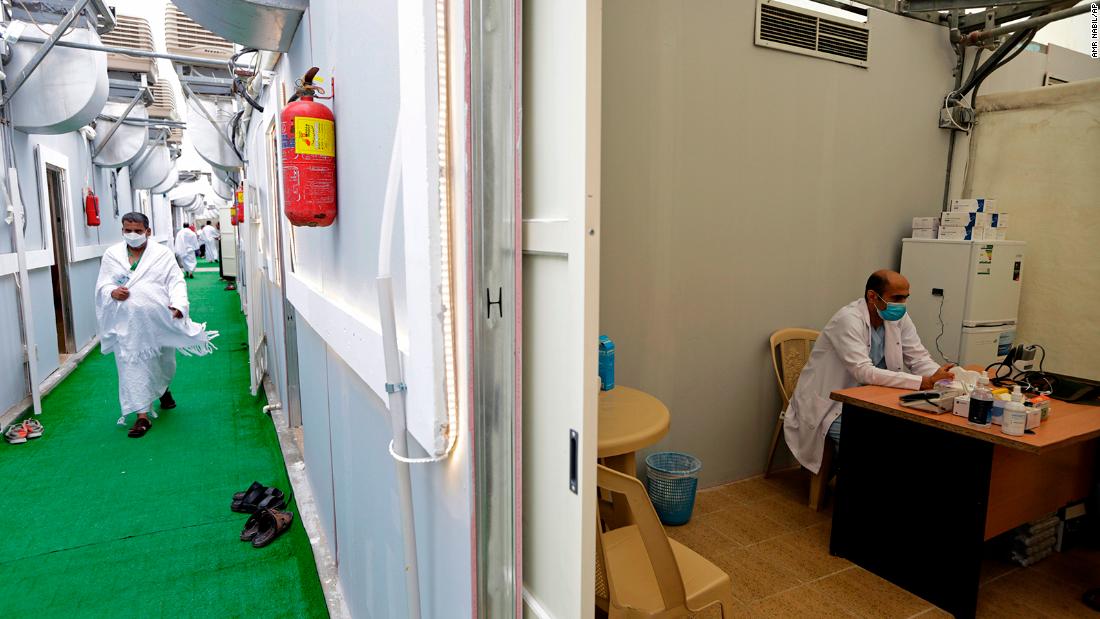 A pilgrim walks in a corridor of a tent camp as a doctor works in a camp clinic in Mina on Sunday.