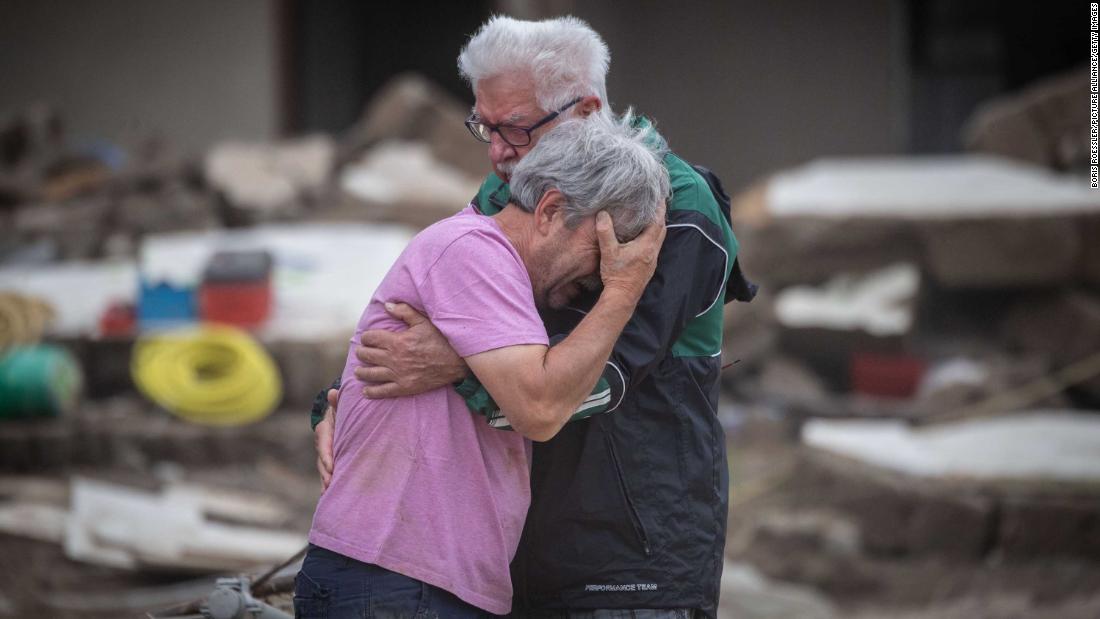 Two brothers embrace Monday, July 19, in front of their parents&#39; home, which was destroyed by flooding in Altenahr, Germany.