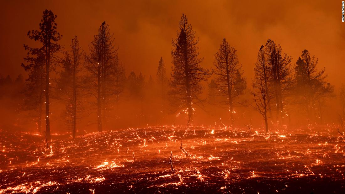 Embers blow across a field as the Sugar Fire burns in Doyle, California, on July 9.