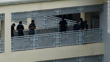 Police officers are seen along a corridor at River Valley High School in Singapore on July 19.