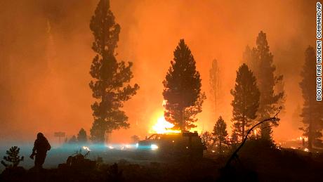 In this photo provided by the Bootleg Fire Incident Command, the Bootleg Fire burns at night in southern Oregon on Saturday, July 17, 2021. The destructive Bootleg Fire, one of the largest in modern Oregon history, has already burned more than 476 square miles (1,210 square kilometers), an area about the size of Los Angeles. The Bootleg Fire is among dozens burning in the parched West.  (Bootleg Fire Incident Command via AP)