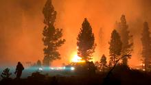 In this photo provided by the Bootleg Fire Incident Command, the Bootleg Fire burns at night in southern Oregon on Saturday, July 17, 2021. The destructive Bootleg Fire, one of the largest in modern Oregon history, has already burned more than 476 square miles (1,210 square kilometers), an area about the size of Los Angeles. The Bootleg Fire is among dozens burning in the parched West.  (Bootleg Fire Incident Command via AP)