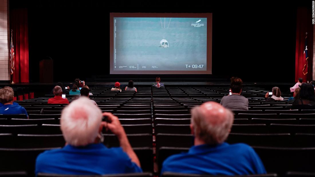 The capsule&#39;s descent is seen during a watch party in Van Horn, Texas.