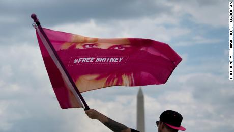 A man waves a &quot;Free Britney&quot; flag during a rally in front of the Lincoln Memorial protesting the conservatorship of Britney Spears July 14, 2021, in Washington, DC. 