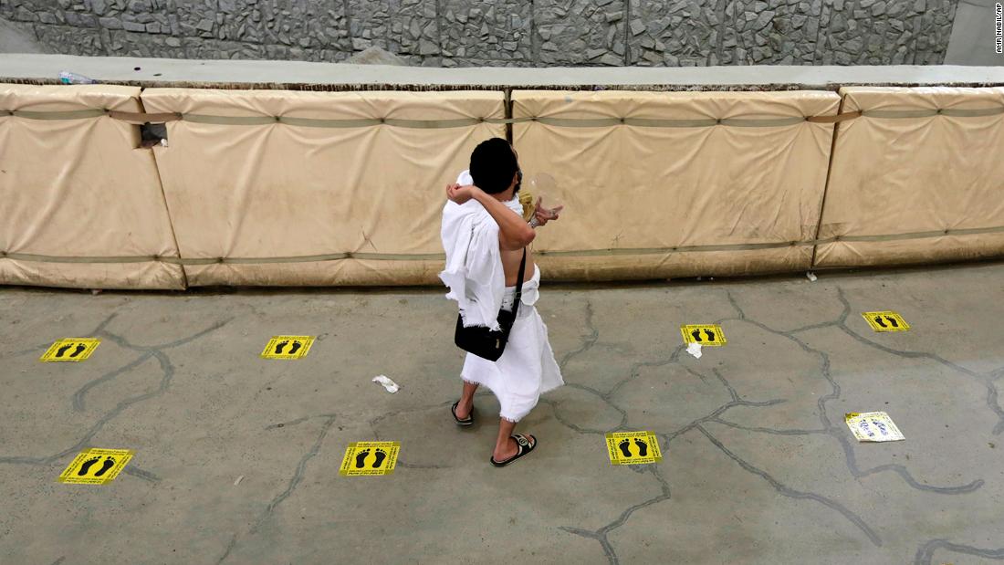 A Muslim pilgrim takes part in the symbolic stoning of the devil Tuesday while he practices social distancing in Mina.