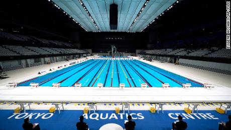 In this April 26, 2021, file photo, Tokyo 2020 Olympic Games Organizing staff prepare a swimming test event at the Tokyo Aquatics Center, one of the venues of the Tokyo 2020 Olympic and Paralympic Games, in Tokyo. 