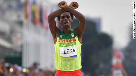 Ethiopia&#39;s Feyisa Lilesa crosses the finish line of the Men&#39;s Marathon athletics event at the Rio 2016 Olympic Games at the Sambodromo on August 21, 2016. 