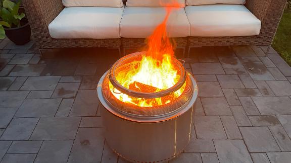 A fireplace and a Solo Stove Yukon protective screen.