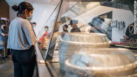 Restaurants are short on staff. Chipotle says raising wages helps
