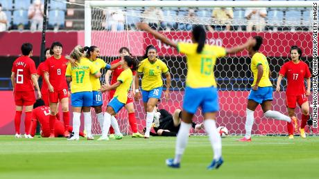Marta celebrates with teammates after scoring her team&#39;s first goal against China. 