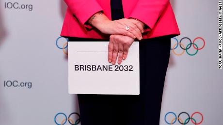 Queensland Premier Annastacia Palaszczuk holds a queue card after the Brisbane announcement during an IOC session in Tokyo.