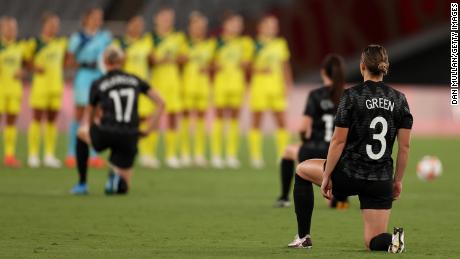 Anna Green in the New Zealand team&#39;s No. 3 jersey takes a knee along with her teammates before the game against Australia.