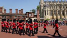 Members of the 1st Battalion Grenadier Guards march out of Windsor Castle in Berkshire after taking part in the Changing of the Guard for the first time since the start of the coronavirus pandemic.