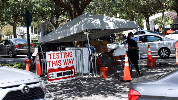 People wait at a testing and vaccination site in Barnett Park, Florida. One in five of all cases in the US are occurring in the state, White House officials say.
