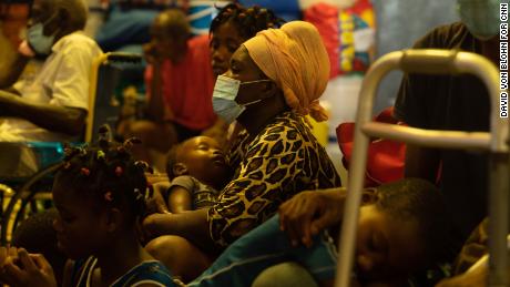 A woman and child sit inside Lekol Kominal school, which has been turned into a refugee camp, in Port-au-Prince.