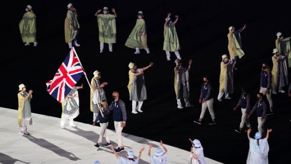 British flag-bearers Hannah Mills and Mohamed Sbihi lead out the team during the opening ceremony's parade of nations. Sbihi, a rower, made history as Great Britain's first Muslim flag-bearer.
