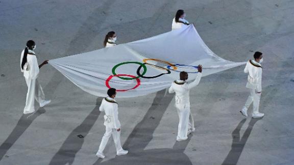 People carry the Olympic flag at the ceremony.