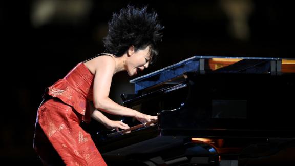 Japanese jazz composer Hiromi Uehara plays the piano during the opening ceremony.