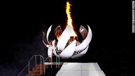 TOKYO, JAPAN - JULY 23: Naomi Osaka of Team Japan lights the Olympic cauldron with the Olympic torch during the Opening Ceremony of the Tokyo 2020 Olympic Games at Olympic Stadium on July 23, 2021 in Tokyo, Japan. (Photo by Maddie Meyer/Getty Images)