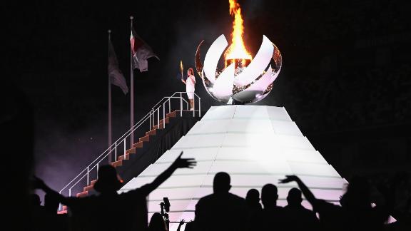 Japanese tennis star Naomi Osaka lights the Olympic cauldron at the end of the opening ceremony on Friday, July 23.